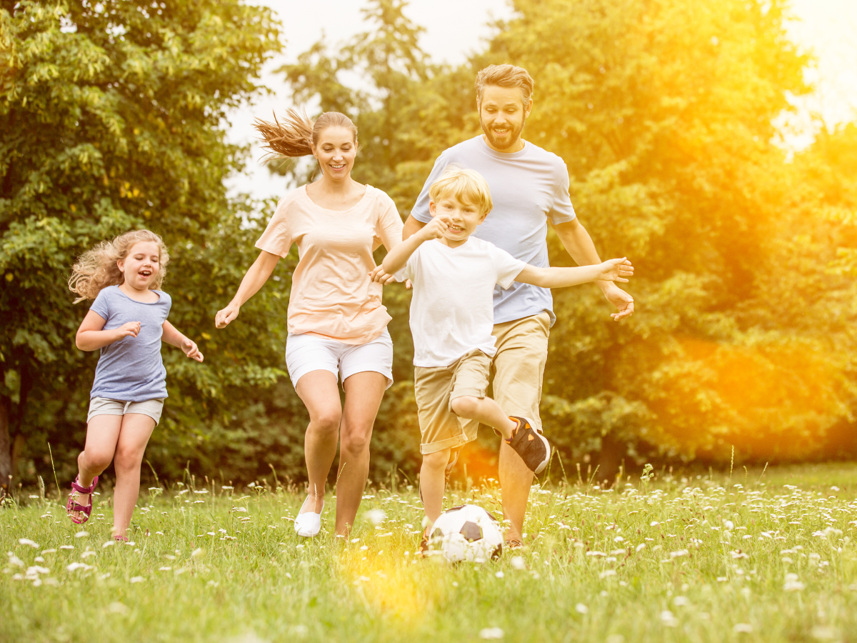 Family Playing Soccer Outdoors