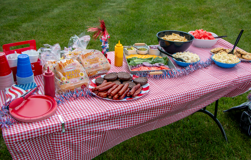 Outdoor Picnic Spread with Burgers and Hot Dogs and Martin's Potato Rolls